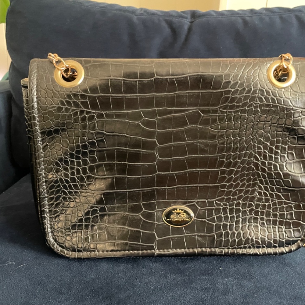 Black faux crocodile leather cross body bag with a chain